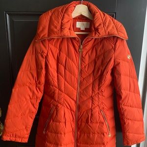Michael Kors long orange jacket in vibrant orange.